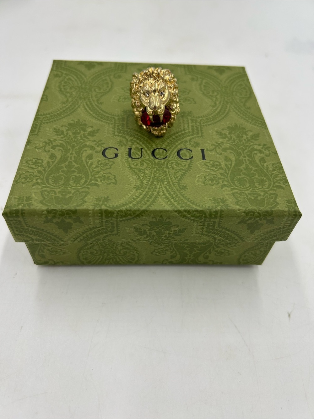 Unisex Gucci, Lionhead motif  gold tone with red crystal size 8.5 made in Italy